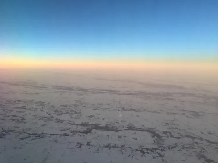 image from a plane window of a snowy landscape. probably over Iowa. photo by mcglynn