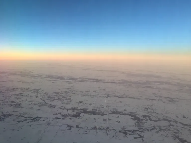 image from a plane window of a snowy landscape. probably over Iowa. photo by mcglynn